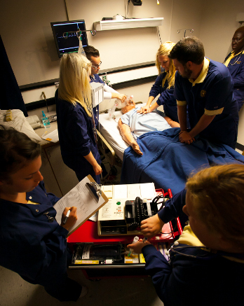 Nurses practice skills on a mannequin.