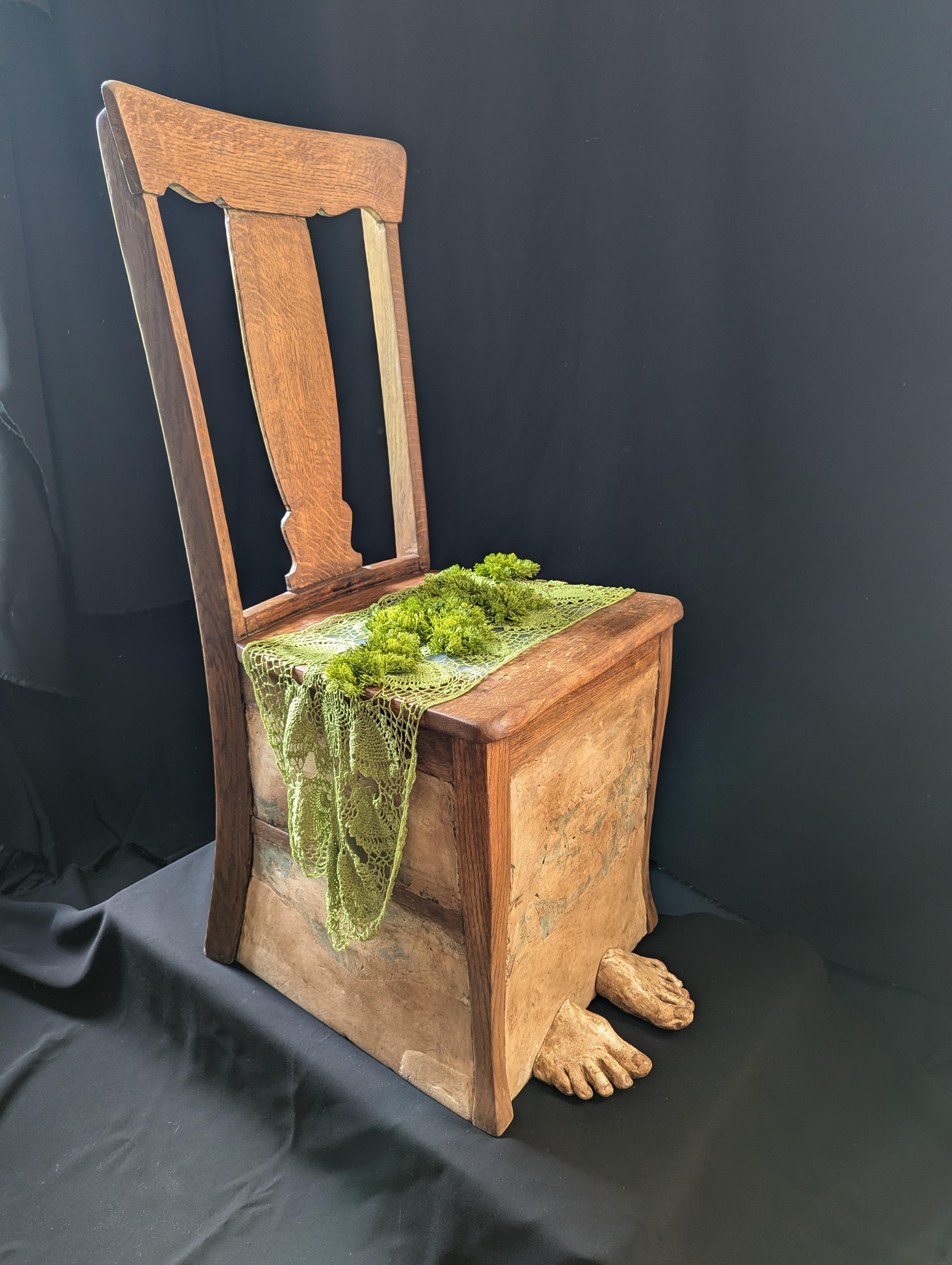 Susan Heggestad, “Inertia,” found chair, plaster, wildflower ink, beeswax, plexiglass, doily with natural dyes, plastic moss and acrylic medium, 2024.  